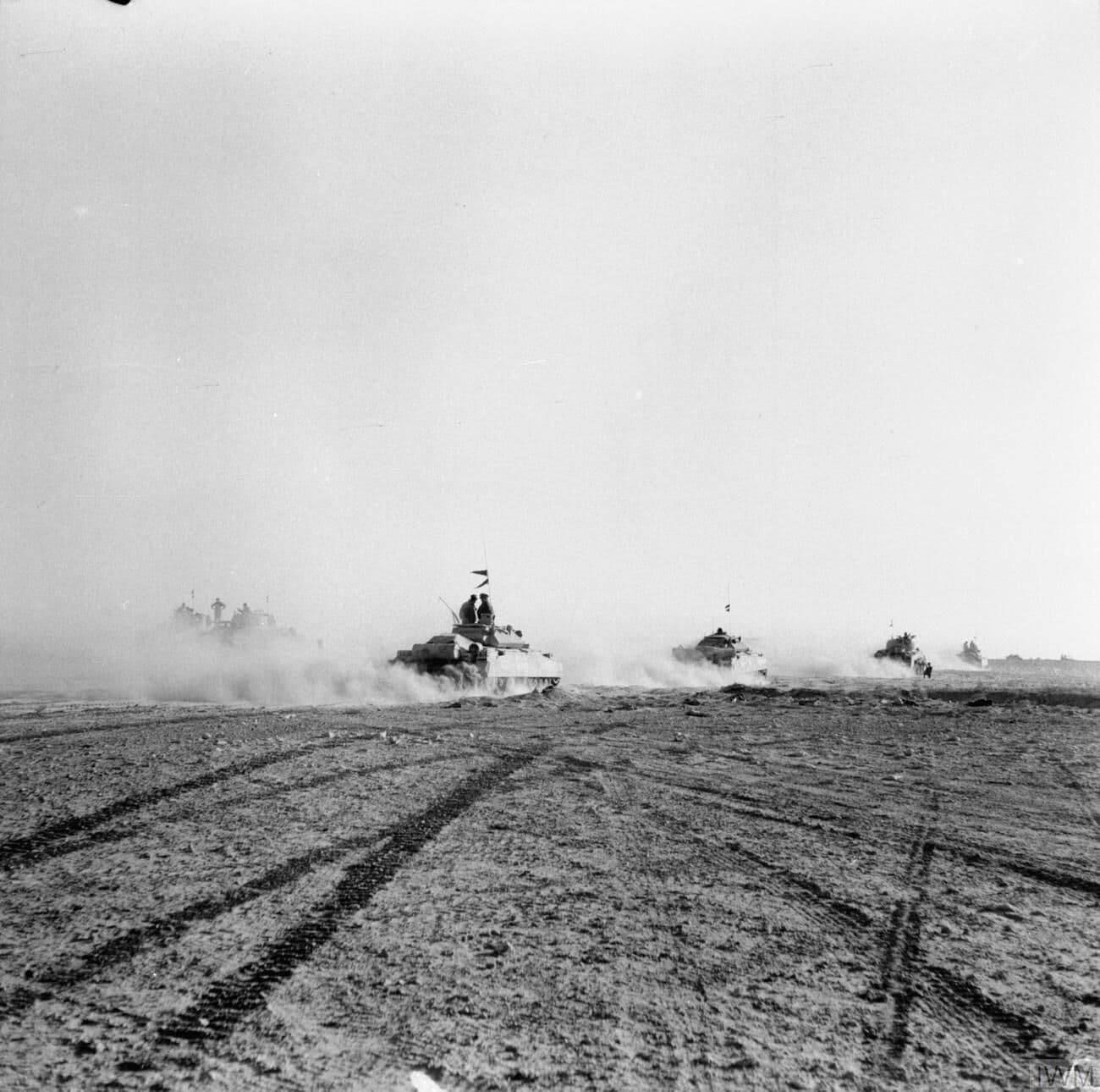British tanks advancing in formation across the desert at El Alamein in 1942