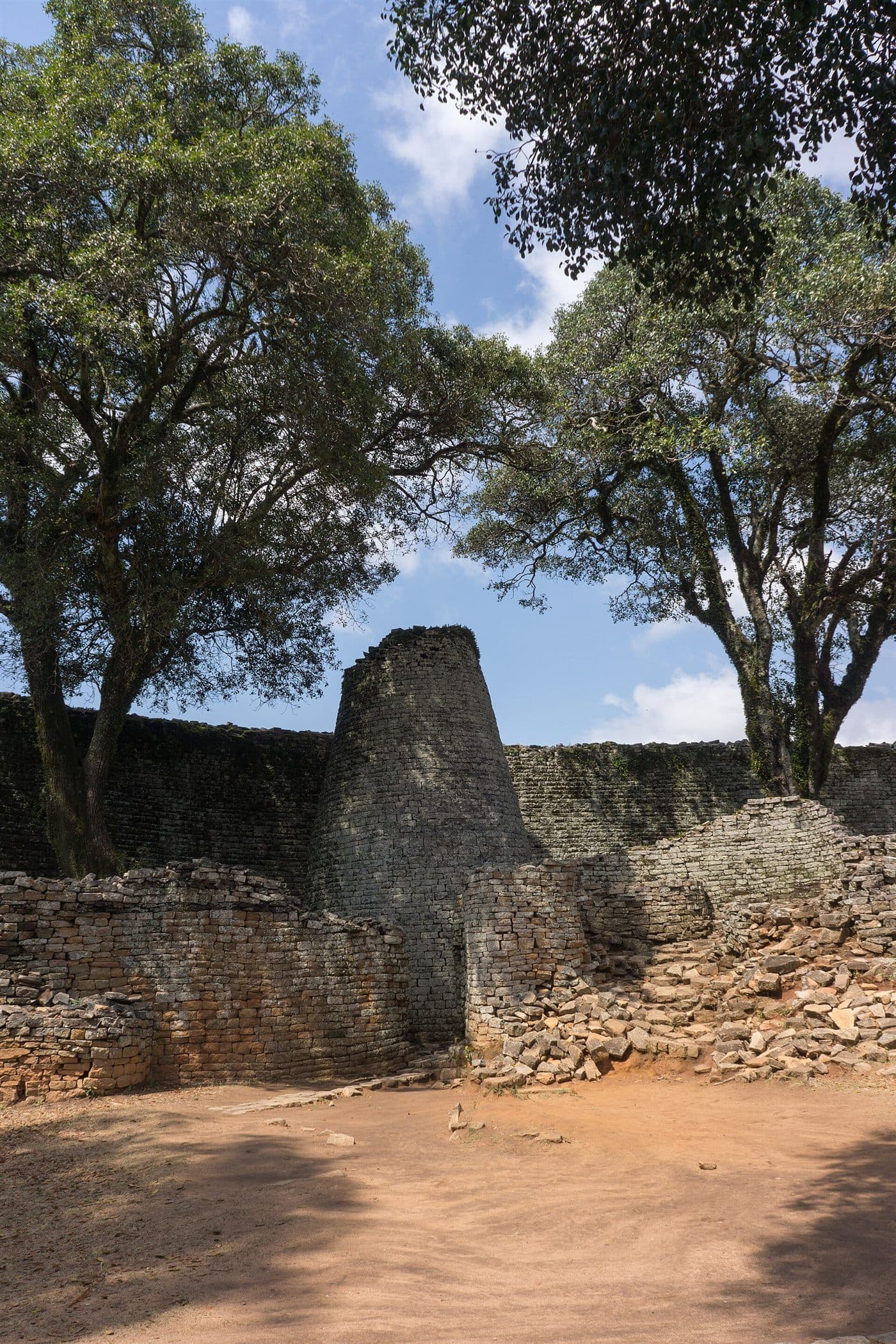 The conical tower of Great Zimbabwe rising inside the curved granite enclosure walls