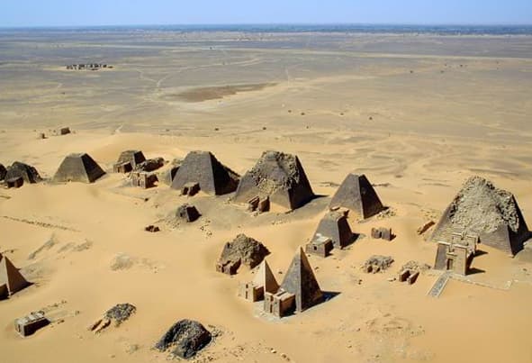 Rows of steep-sided pyramids rising from the desert sands at Meroë in Sudan