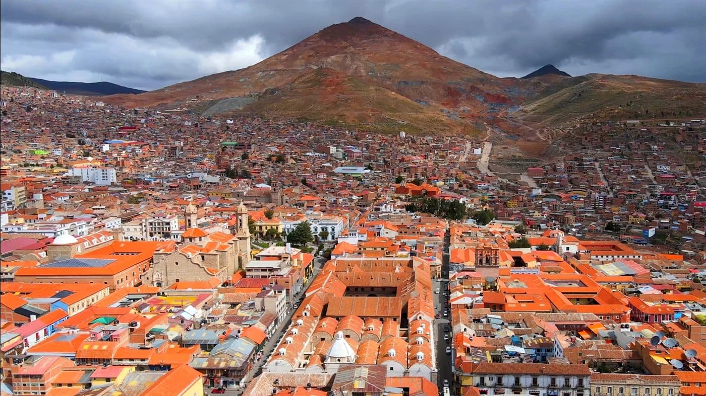 Aerial view of the city of Potosí with the barren cone of Cerro Rico rising behind it