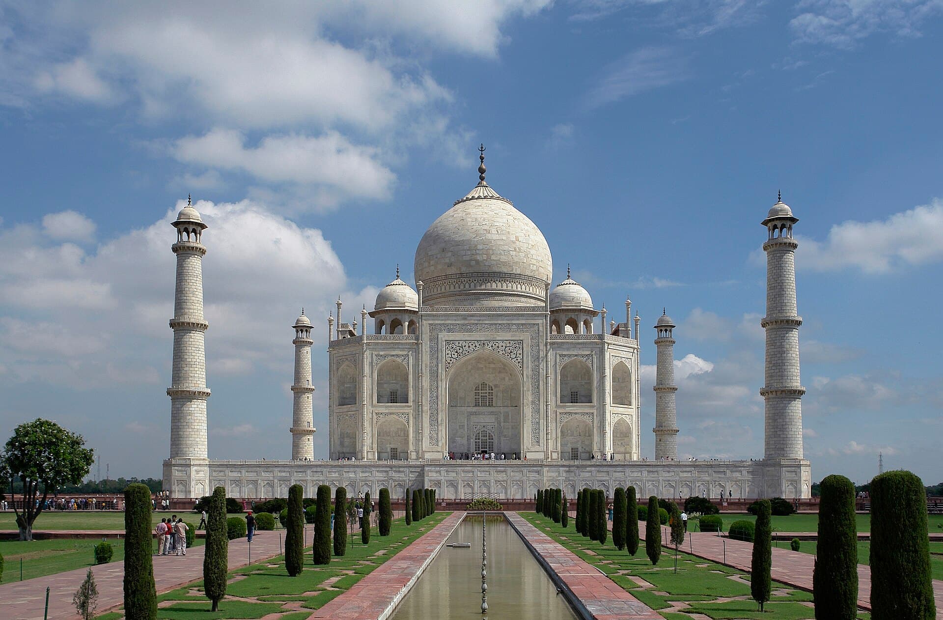The Taj Mahal's white marble dome and minarets reflected in its long water channel