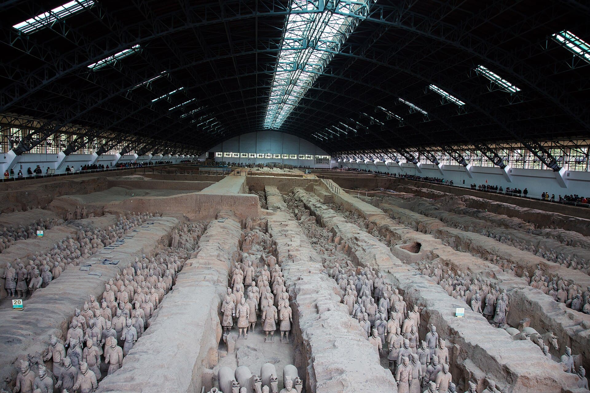 Rows of terracotta warriors standing in their excavation pit at Xi'an