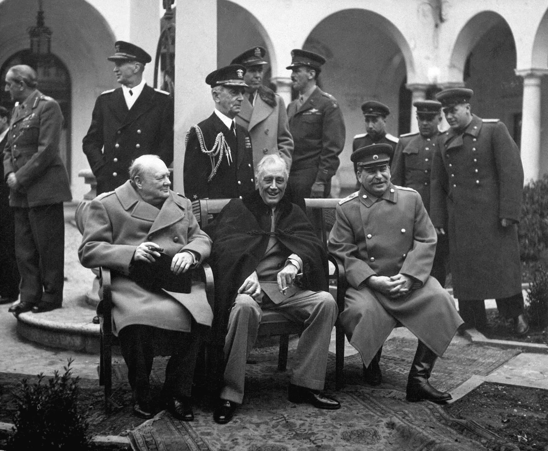 Churchill, Roosevelt and Stalin seated side by side at the Yalta Conference